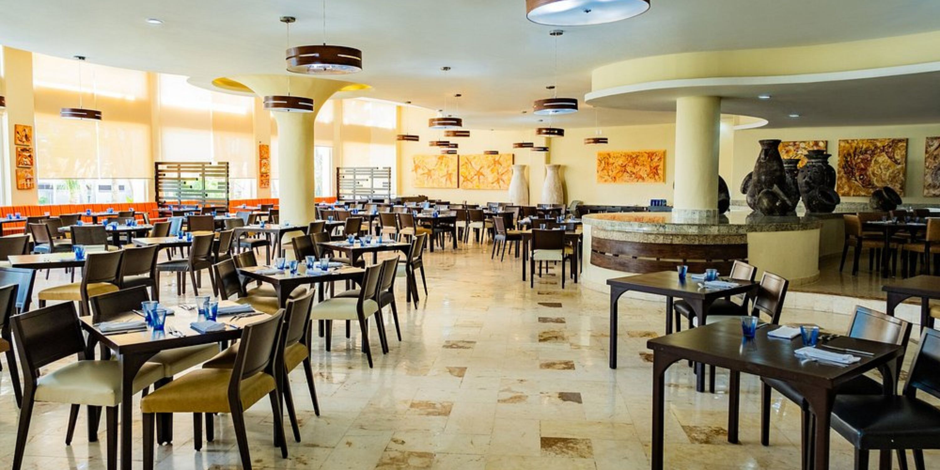 Chic restaurant at Iberostar Selection Riviera Cancun set for a wedding, bathed in natural light.