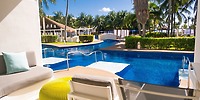 Poolside patio with lounge chairs at Iberostar Selection Riviera Cancun, ideal for a destination wedding.