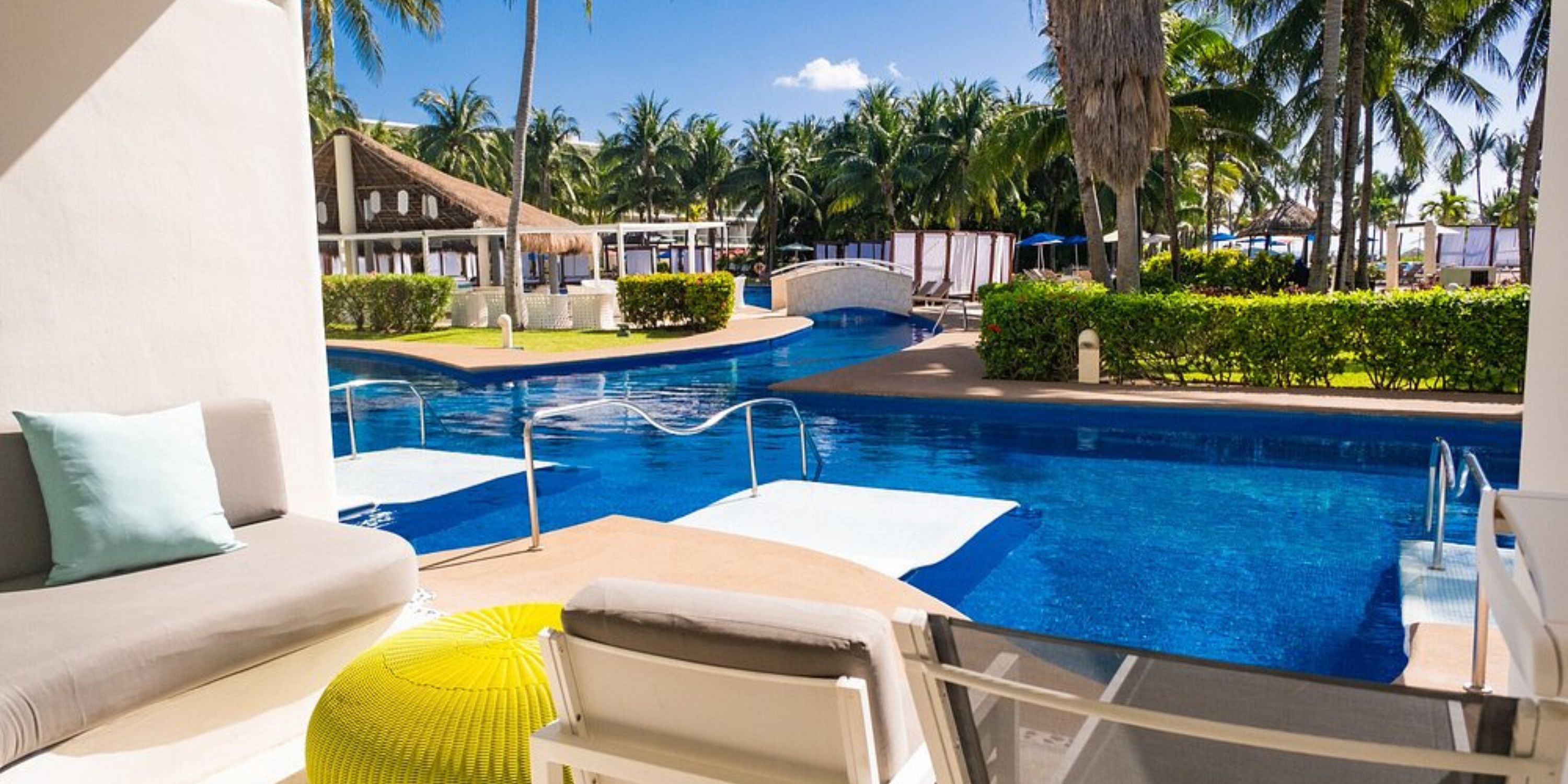 Poolside patio with lounge chairs at Iberostar Selection Riviera Cancun, ideal for a destination wedding.