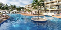 Outdoor pool with lounge chairs at Iberostar Selection Riviera Cancun, perfect for a destination wedding backdrop.