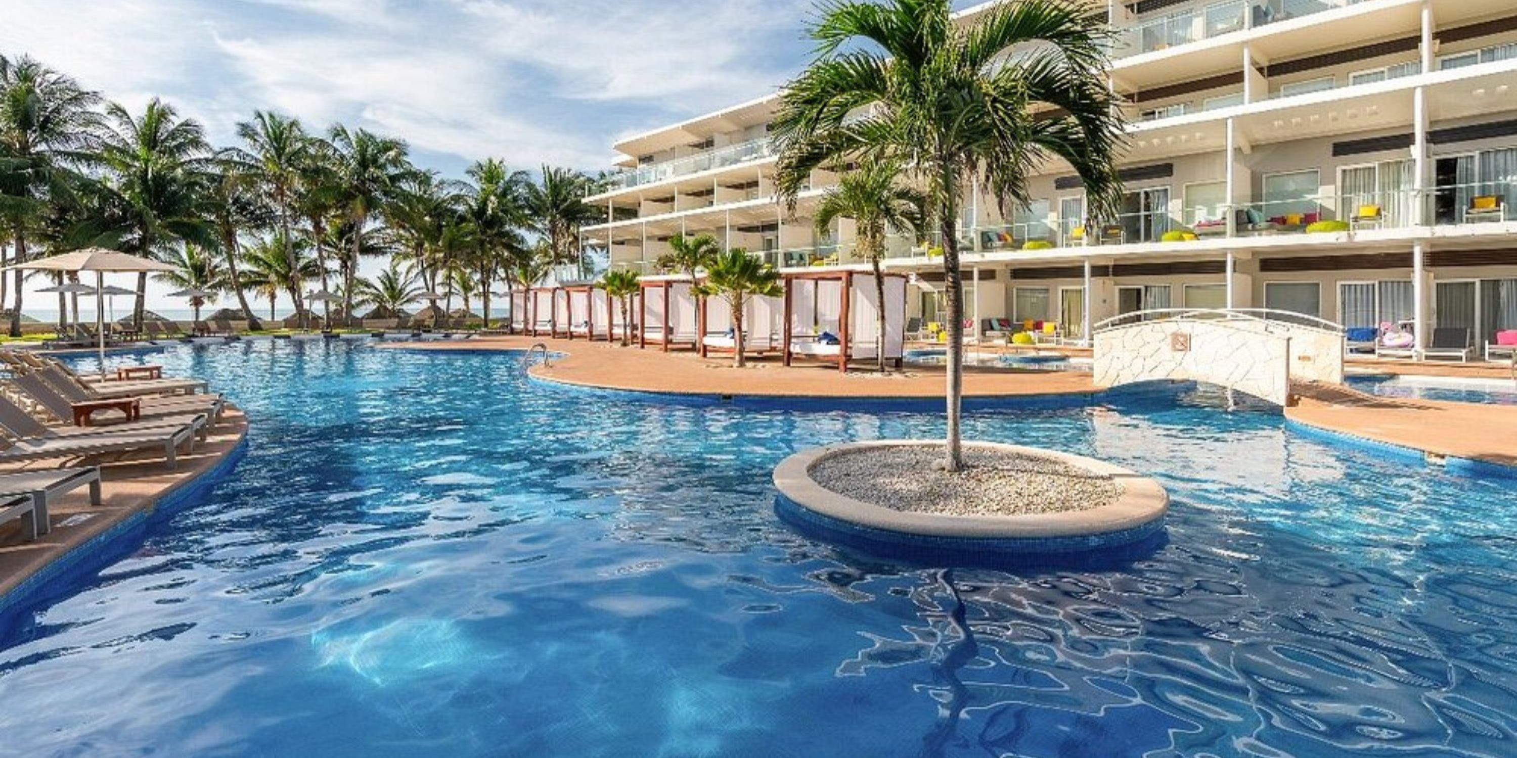 Outdoor pool with lounge chairs at Iberostar Selection Riviera Cancun, perfect for a destination wedding backdrop.