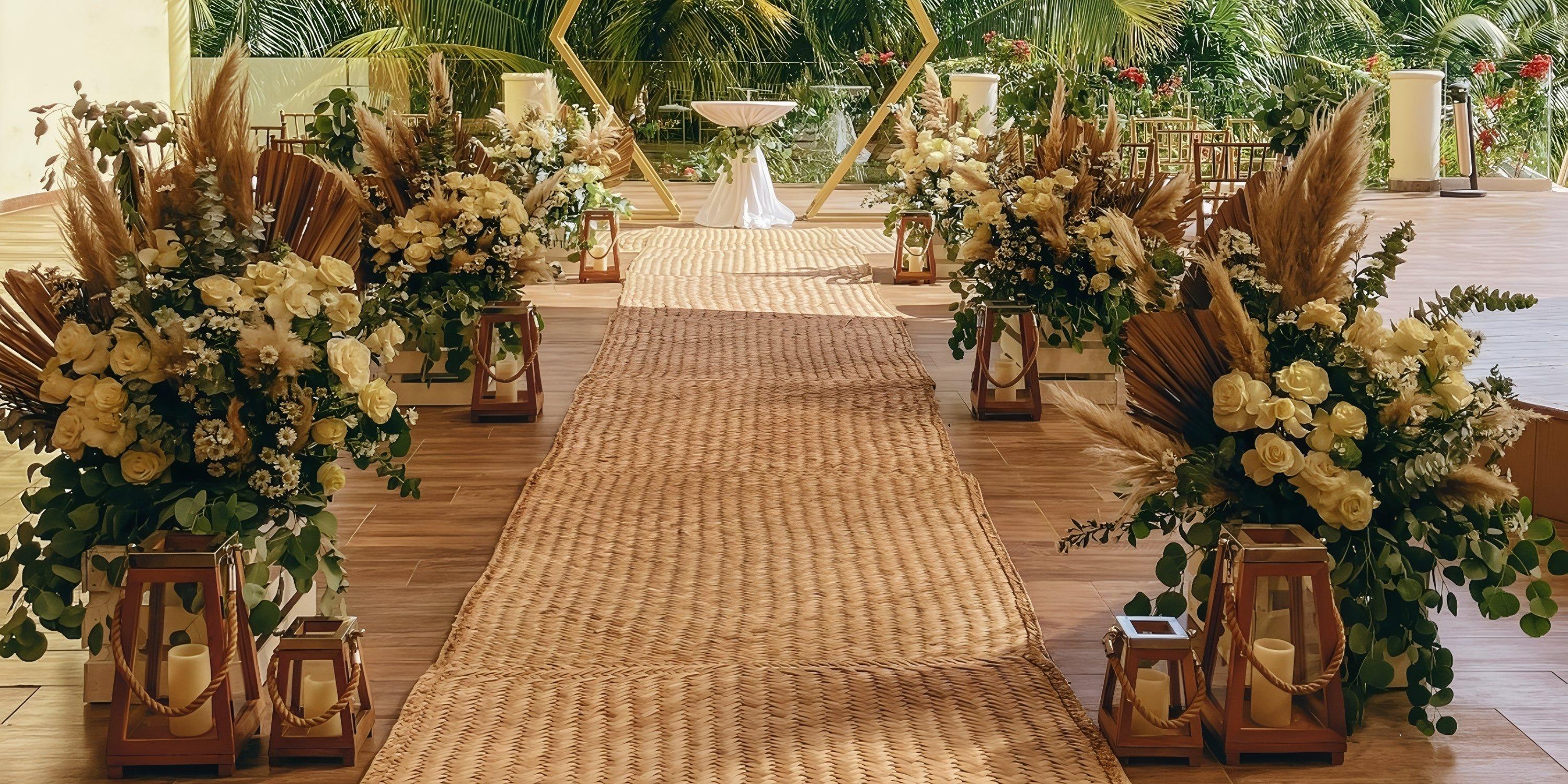 Destination wedding aisle indoors at Iberostar Selection Riviera Cancun, adorned with florals and lanterns.
