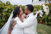 Leah and Ben share an intimate moment at their destination wedding, surrounded by lush greenery outdoors.