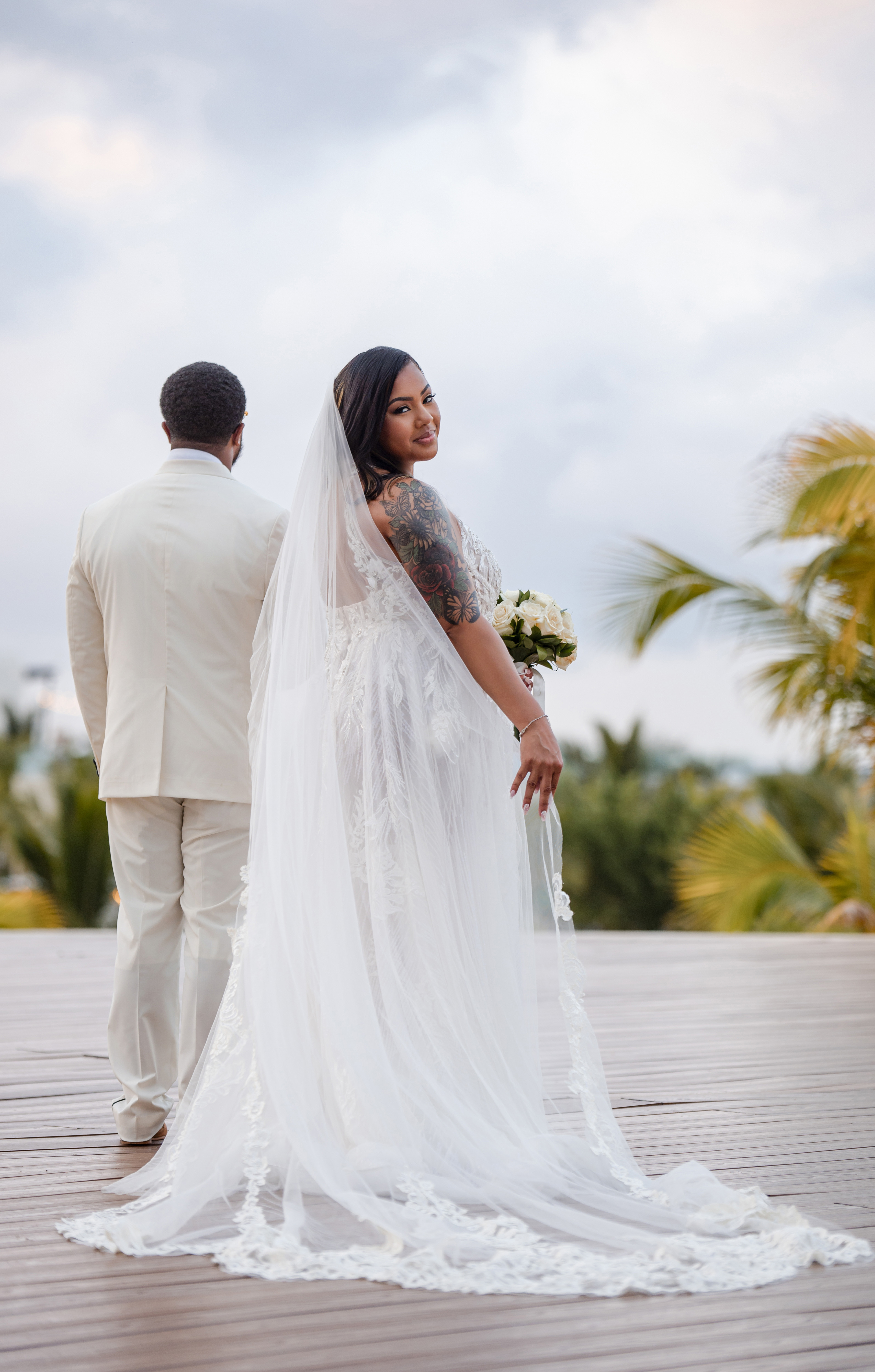 A woman wearing the "Leah and Ben (Copy)" gown, perfect for a romantic destination wedding.