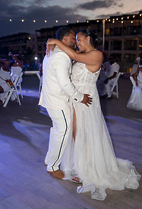 Leah and Ben embrace and smile as they dance together, celebrating at a joyful destination wedding.