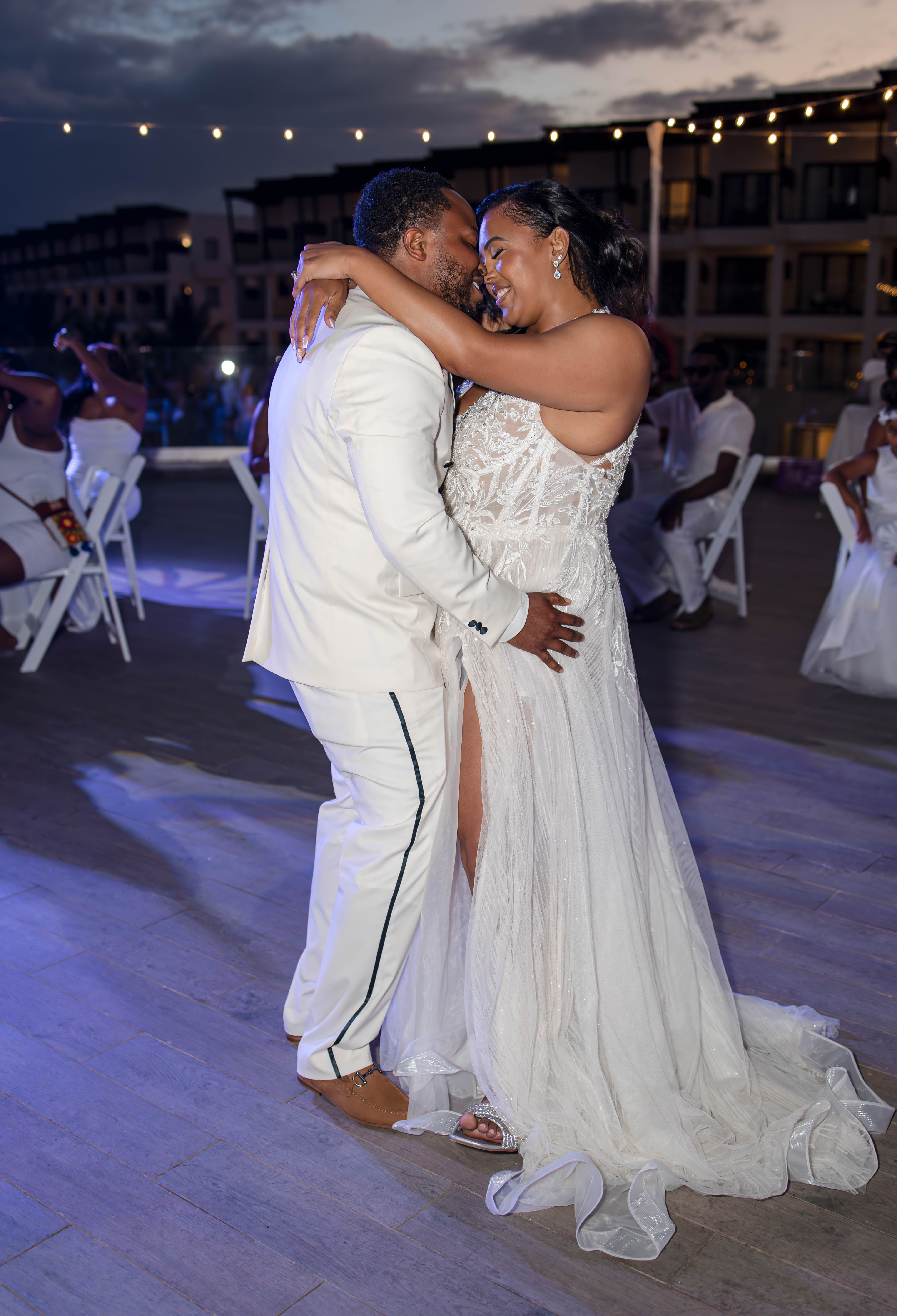 Leah and Ben embrace and smile as they dance together, celebrating at a joyful destination wedding.