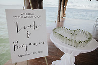 Wedding sign for Kaitlyn and Chad at their destination wedding, next to heart-shaped shot glass display.