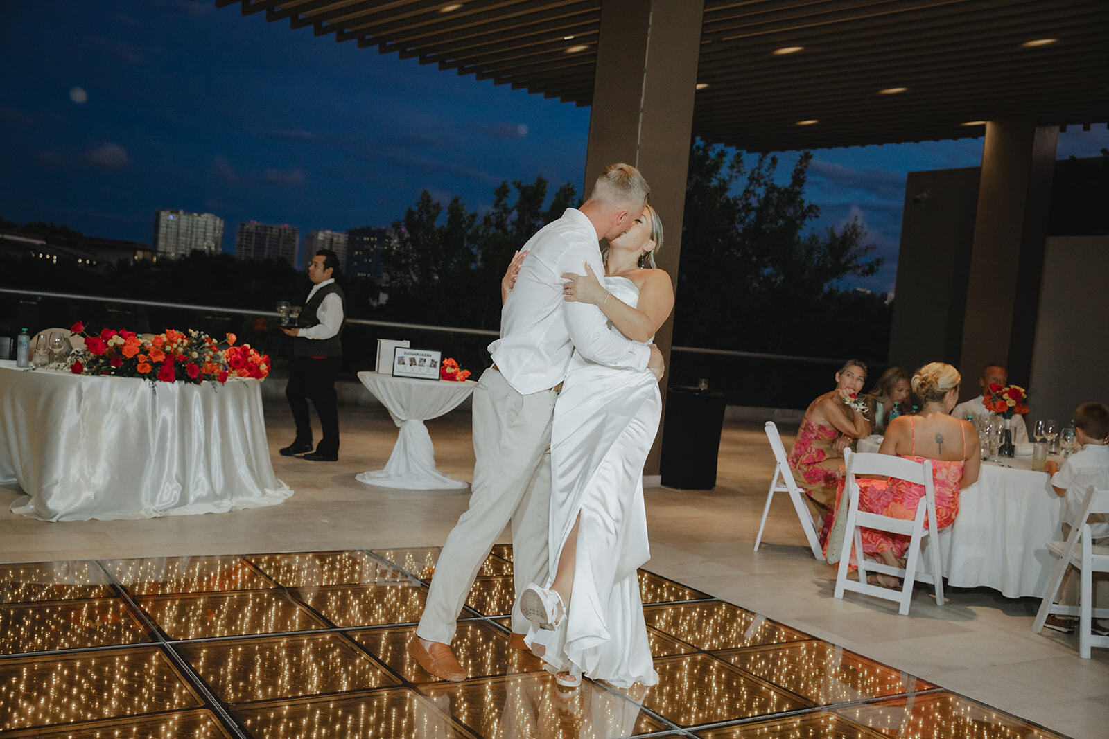 Kaitlyn and Chad (Copy) dance on a glowing floor at an outdoor destination wedding in the evening.
