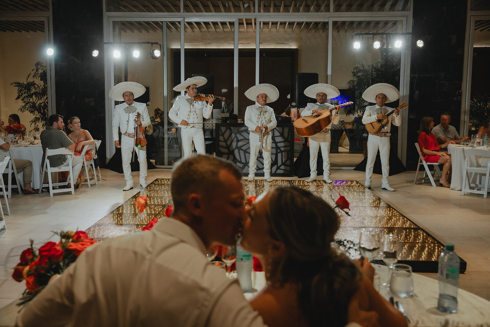 A mariachi band plays as Kaitlyn and Chad share a kiss at their destination wedding.