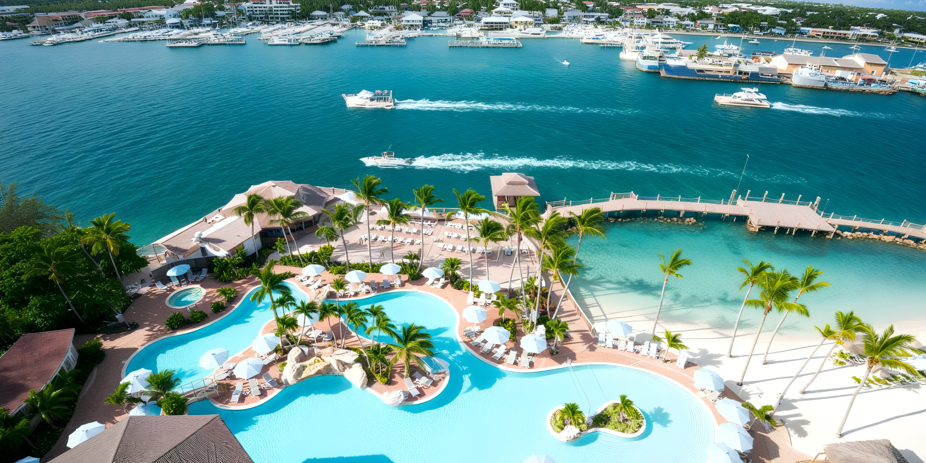 Aerial view of Warwick Paradise Island Bahamas—perfect resort pool, sandy beach, marina, turquoise water for a destination wedding.