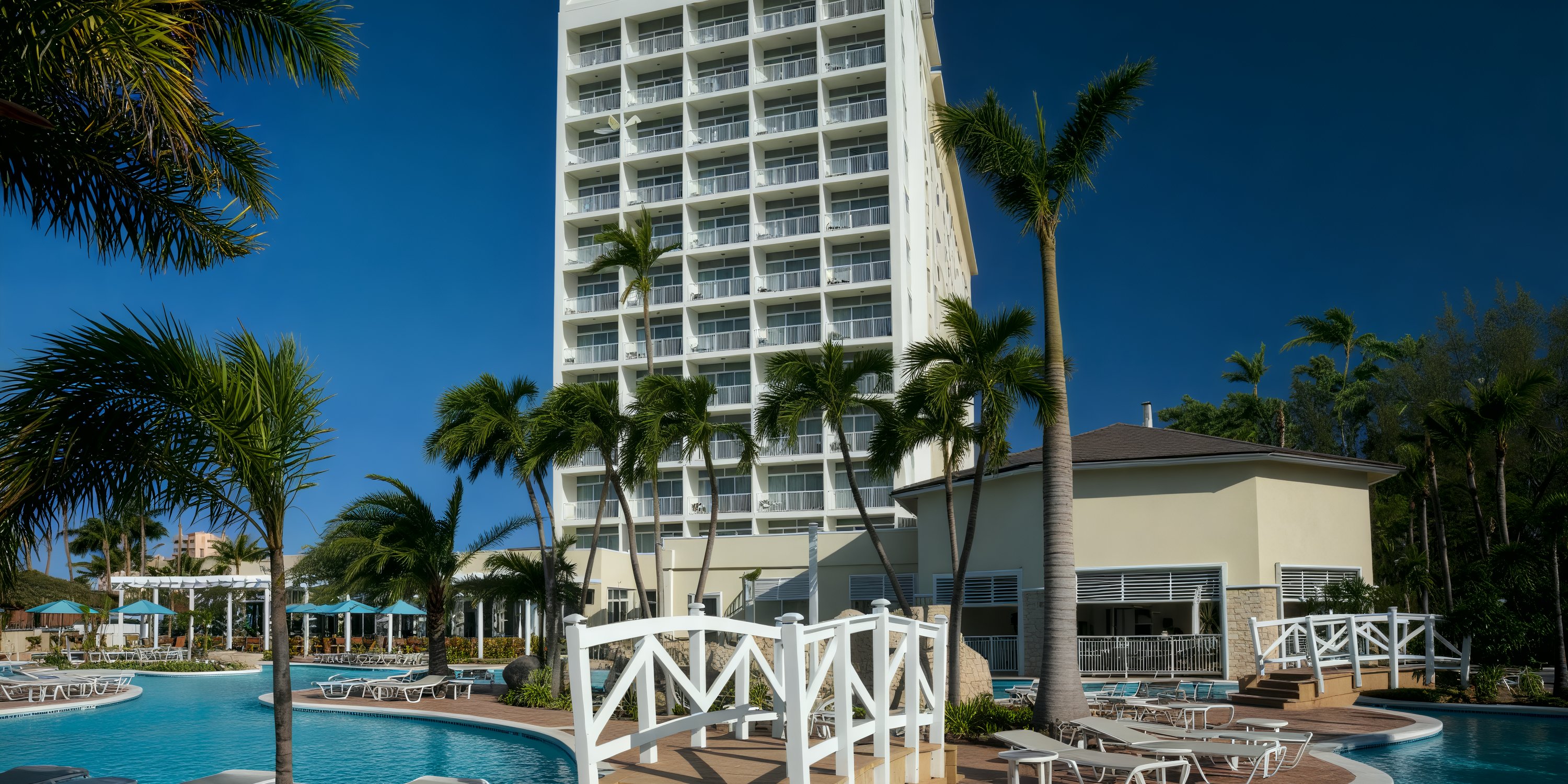 Warwick Paradise Island Bahamas hotel, ideal for a destination wedding, with balconies, palms, and pool.