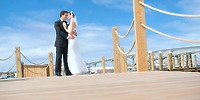 Bride and groom in formal wear on a dock during a destination wedding at Warwick Paradise Island Bahamas.