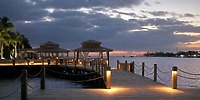 Pier with gazebos at Warwick Paradise Island Bahamas, ideal for destination wedding sunsets and lit walkway.