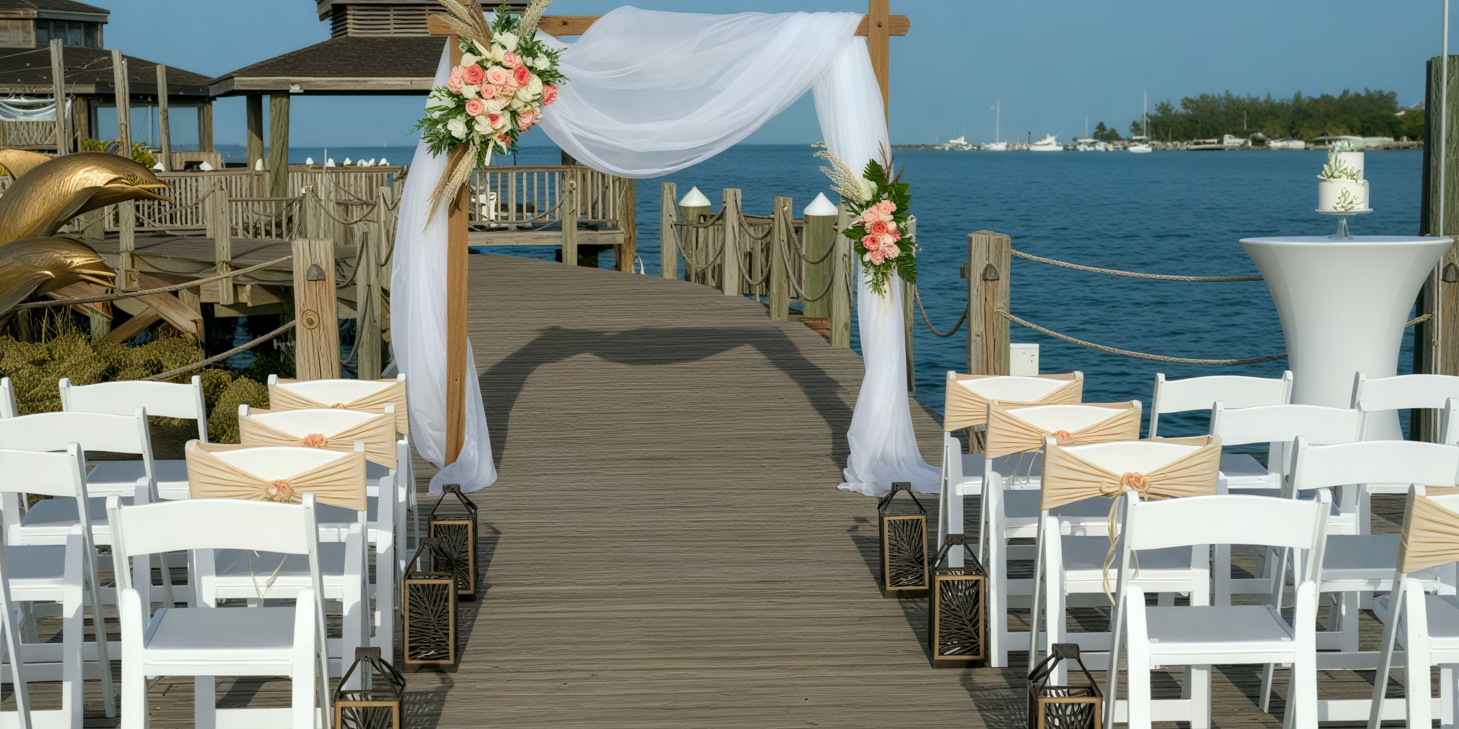 Destination wedding dock setup at Warwick Paradise Island Bahamas, featuring decorated chairs and arch.