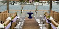 Destination wedding setup at Warwick Paradise Island Bahamas, featuring purple accents on a wooden dock.