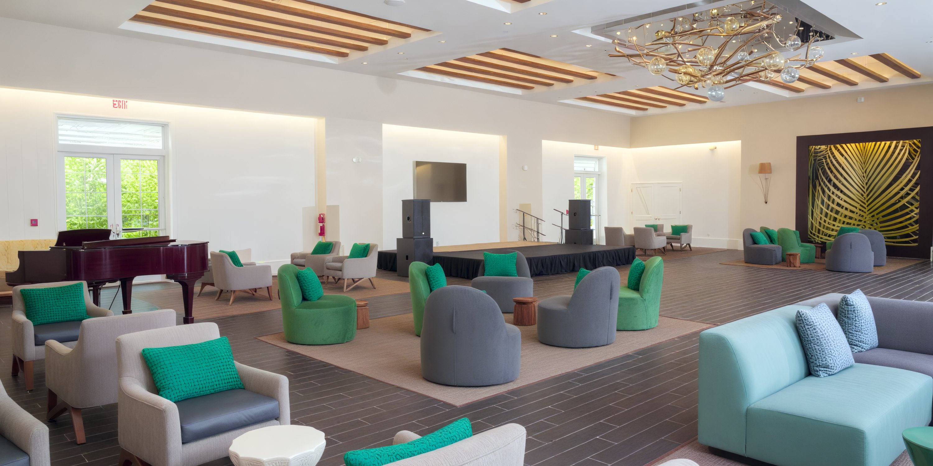 Warwick Paradise Island Bahamas: elegant lounge with stage, piano, and bright windows for destination weddings.