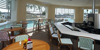 Warwick Paradise Island Bahamas offers a poolside bar with wicker seats—perfect for destination weddings.