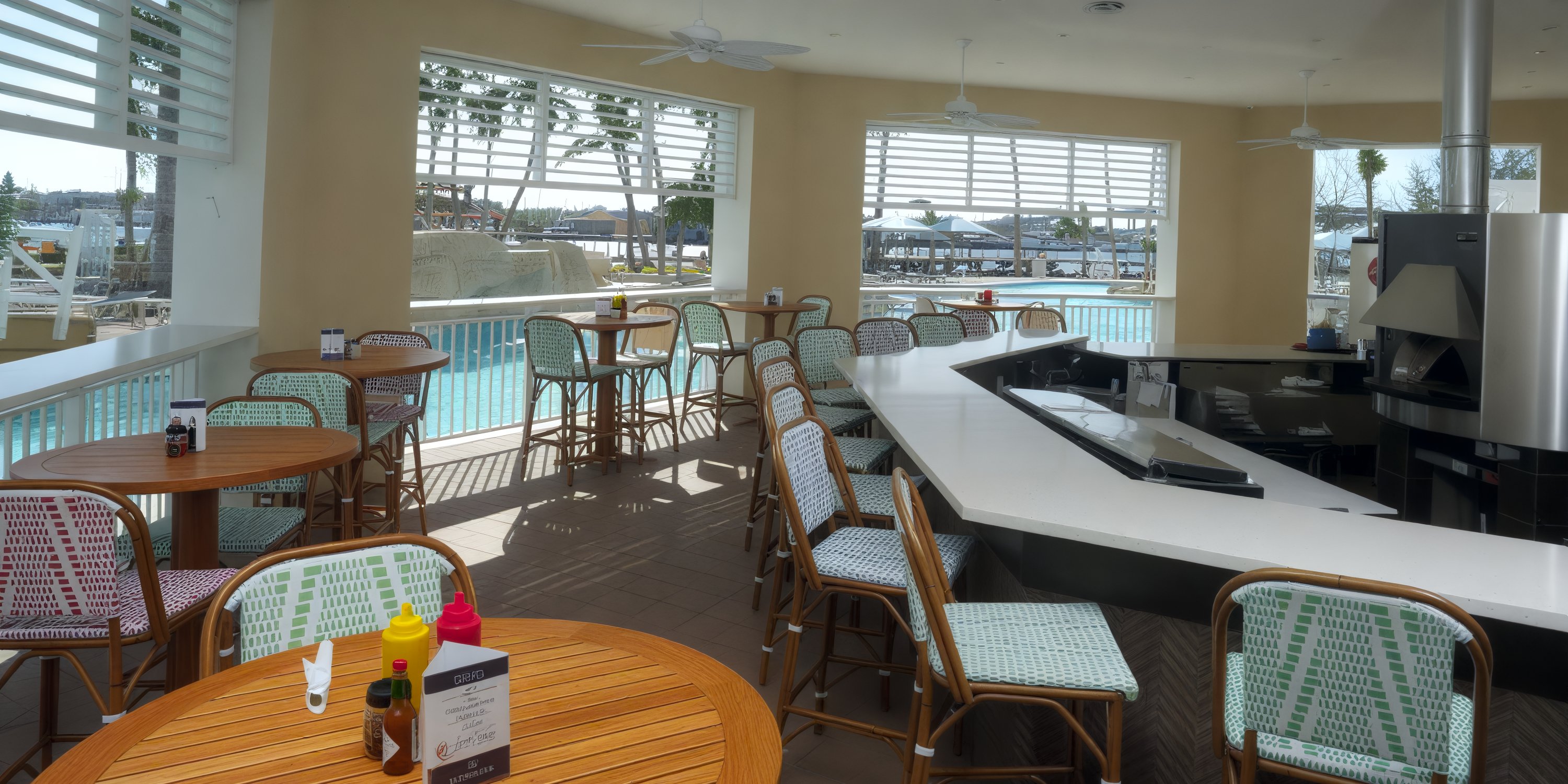 Warwick Paradise Island Bahamas offers a poolside bar with wicker seats—perfect for destination weddings.