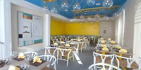 Chic Warwick Paradise Island wedding venue: yellow walls, glass lights, and tables set for a destination wedding.