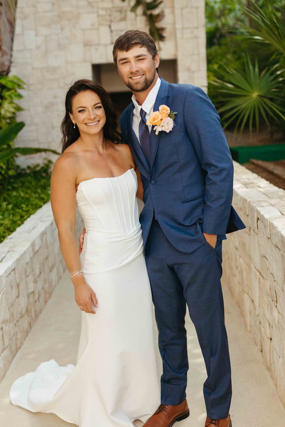 Shirley and William pose together outside as bride and groom at their destination wedding.