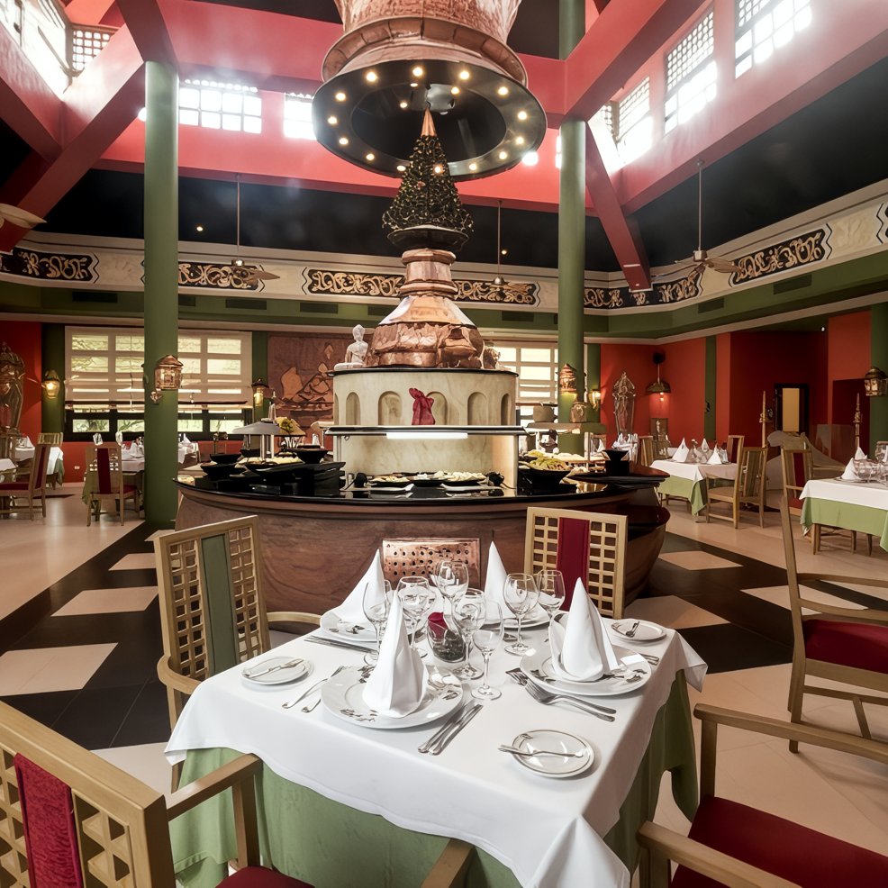 Chic restaurant set up for a destination wedding, with elegant tables, centerpieces, and red-green accents.
