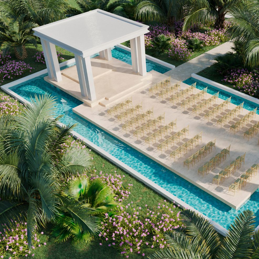 Scenic destination wedding venue with rows of chairs facing a pavilion, surrounded by water and greenery.