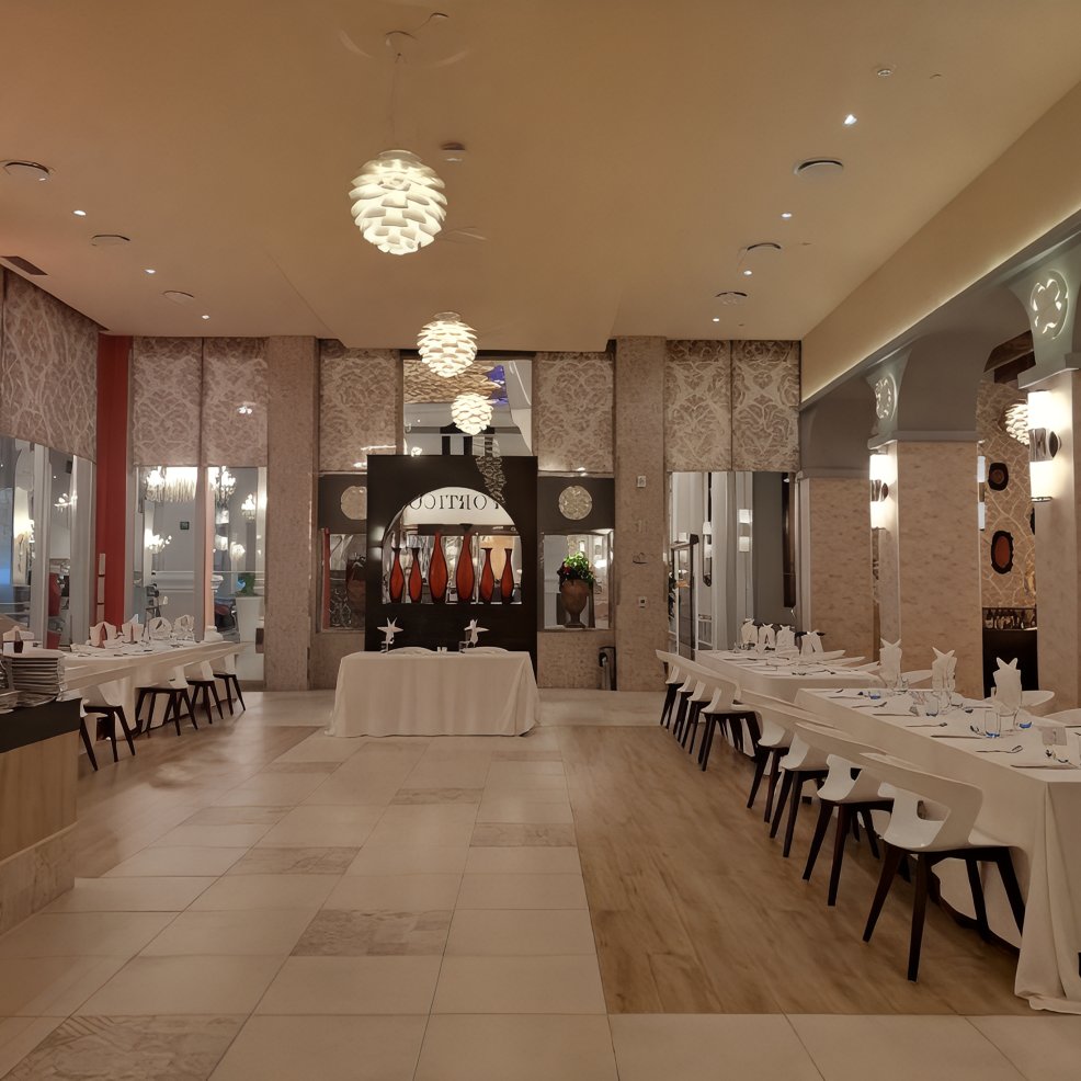 Modern restaurant interior perfect for a destination wedding, with elegant tables and decorative lighting.