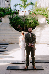 Shirley and William (Copy) pose in wedding attire on a sandy path at their destination wedding.