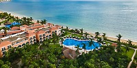 Aerial view of Ocean Coral and Turquesa resort&mdash;perfect for a destination wedding with pool, palms, ocean.