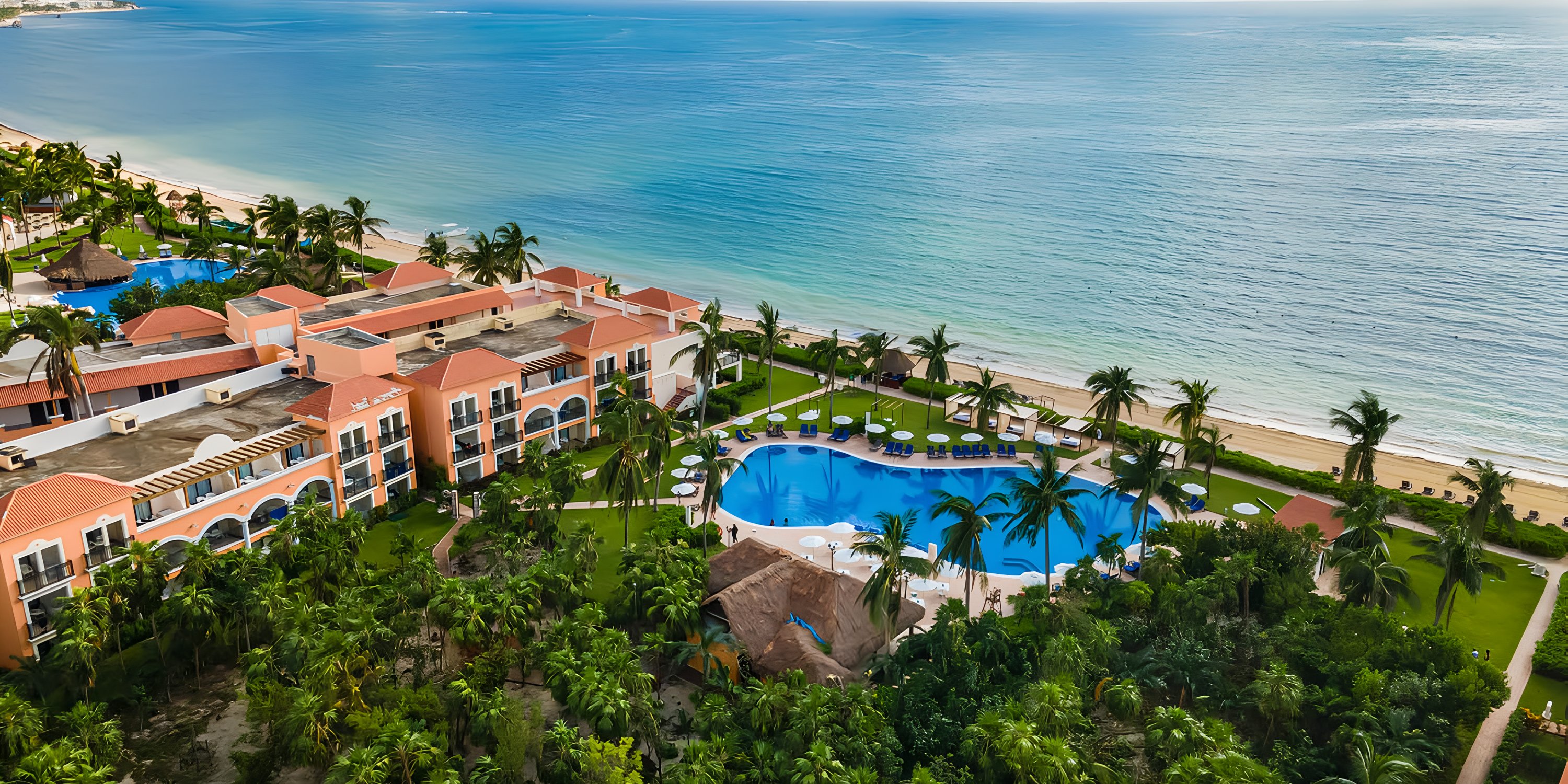 Aerial view of Ocean Coral and Turquesa resort&mdash;perfect for a destination wedding with pool, palms, ocean.