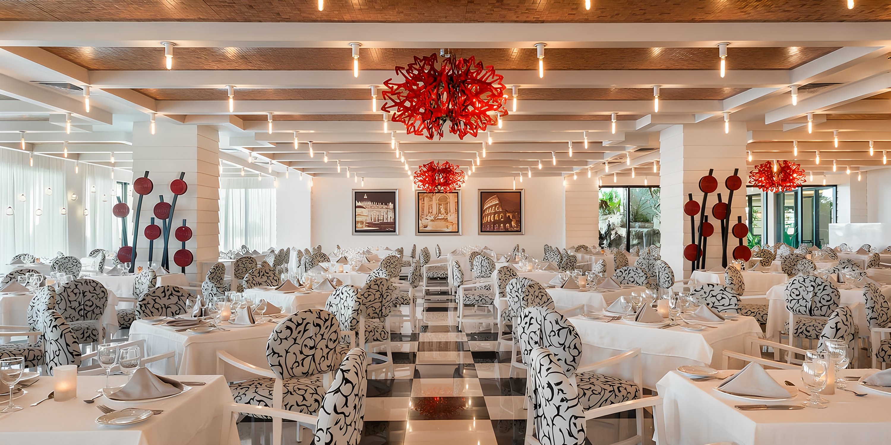 Ocean Coral and Turquesa offers a destination wedding setting with patterned chairs and red chandeliers.