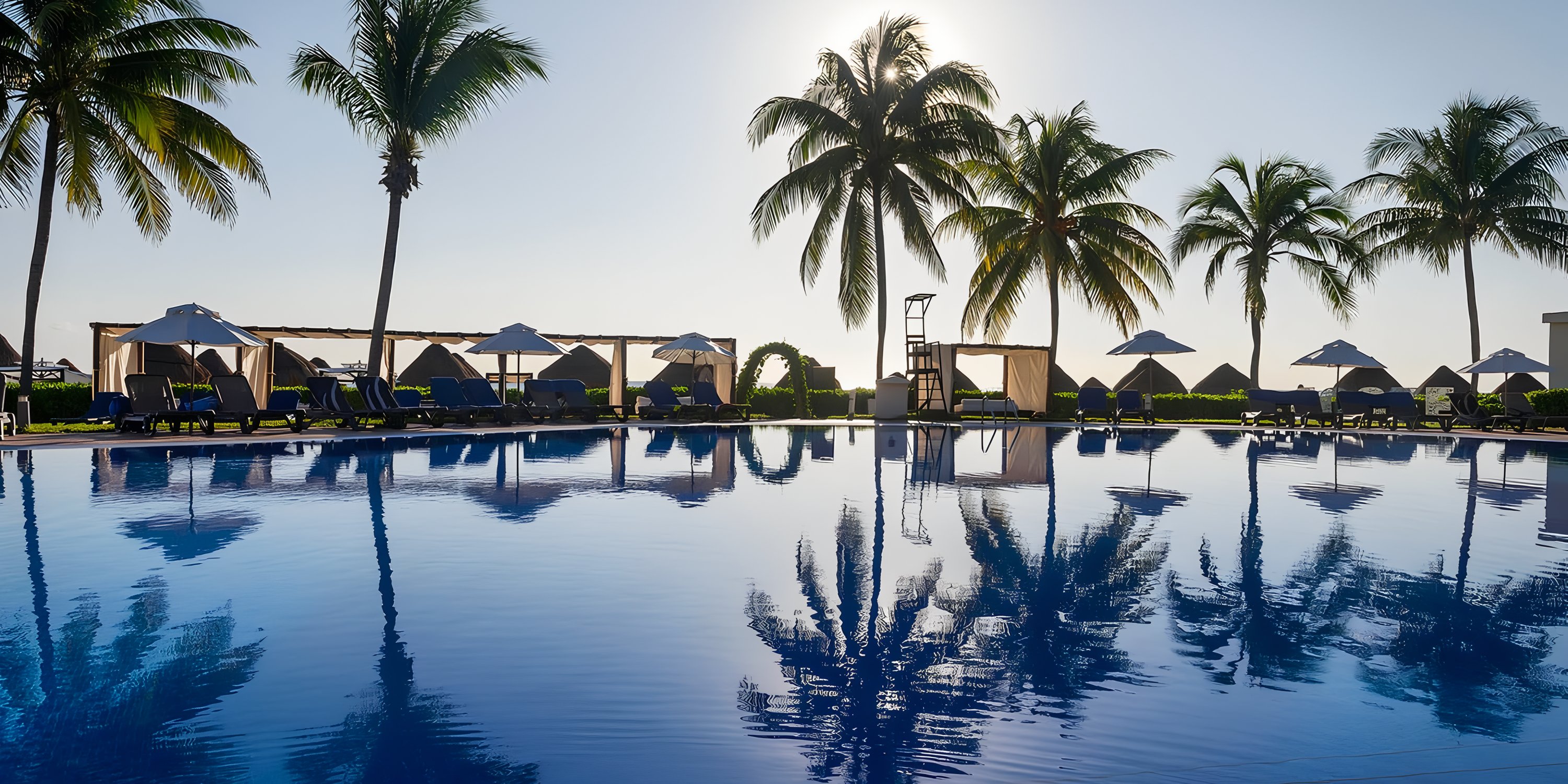 Ocean Coral and Turquesa&rsquo;s pool, surrounded by lounge chairs and palms, is ideal for a destination wedding.