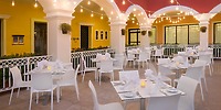Patio at Ocean Coral and Turquesa, perfect for a destination wedding, with white tables and string lights.