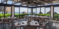 Modern dining at Ocean Coral and Turquesa, perfect for destination weddings, with ocean views and thatched huts.