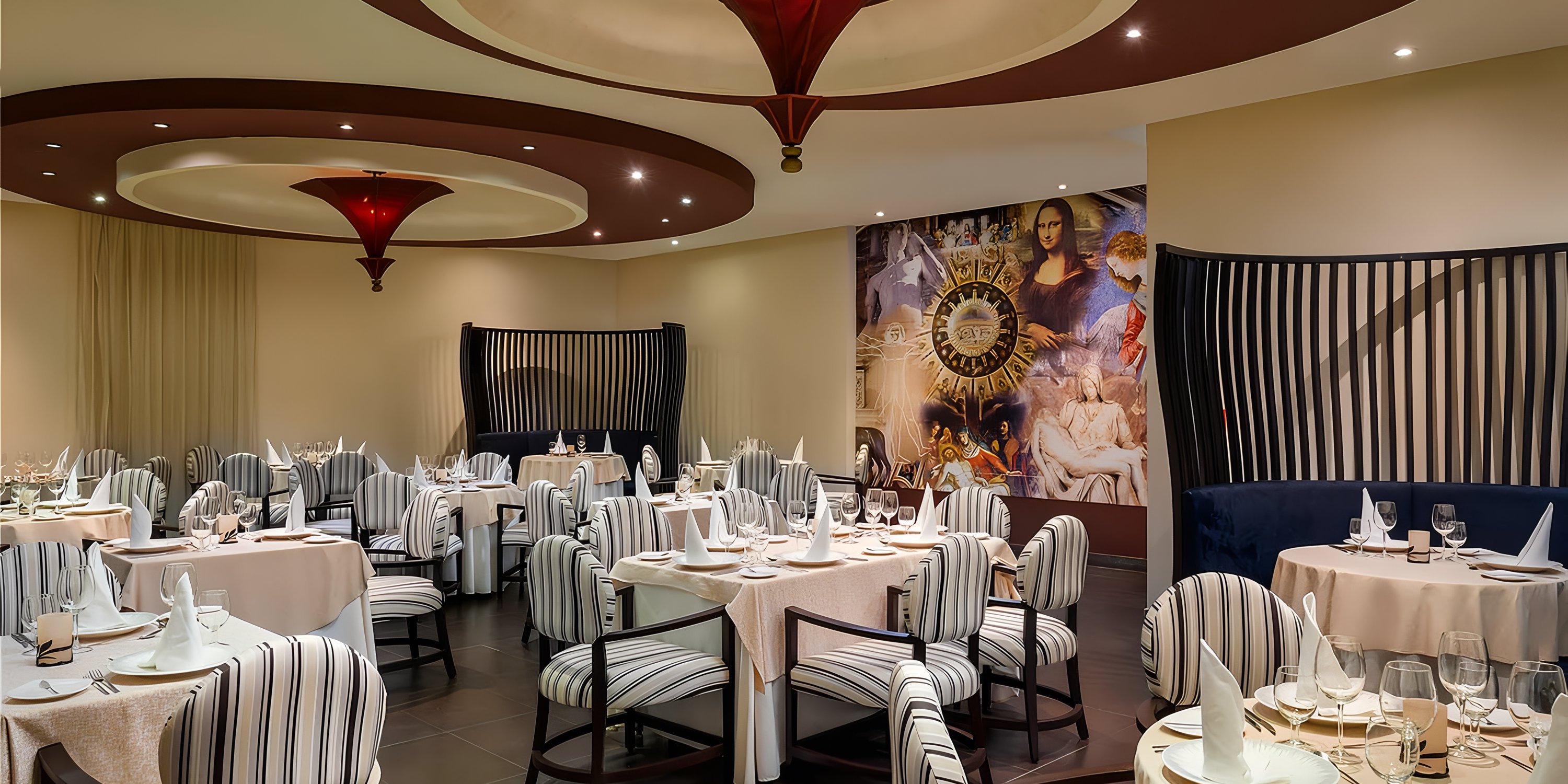 Ocean Coral and Turquesa, perfect for a destination wedding, has striped chairs, round tables, and art murals.