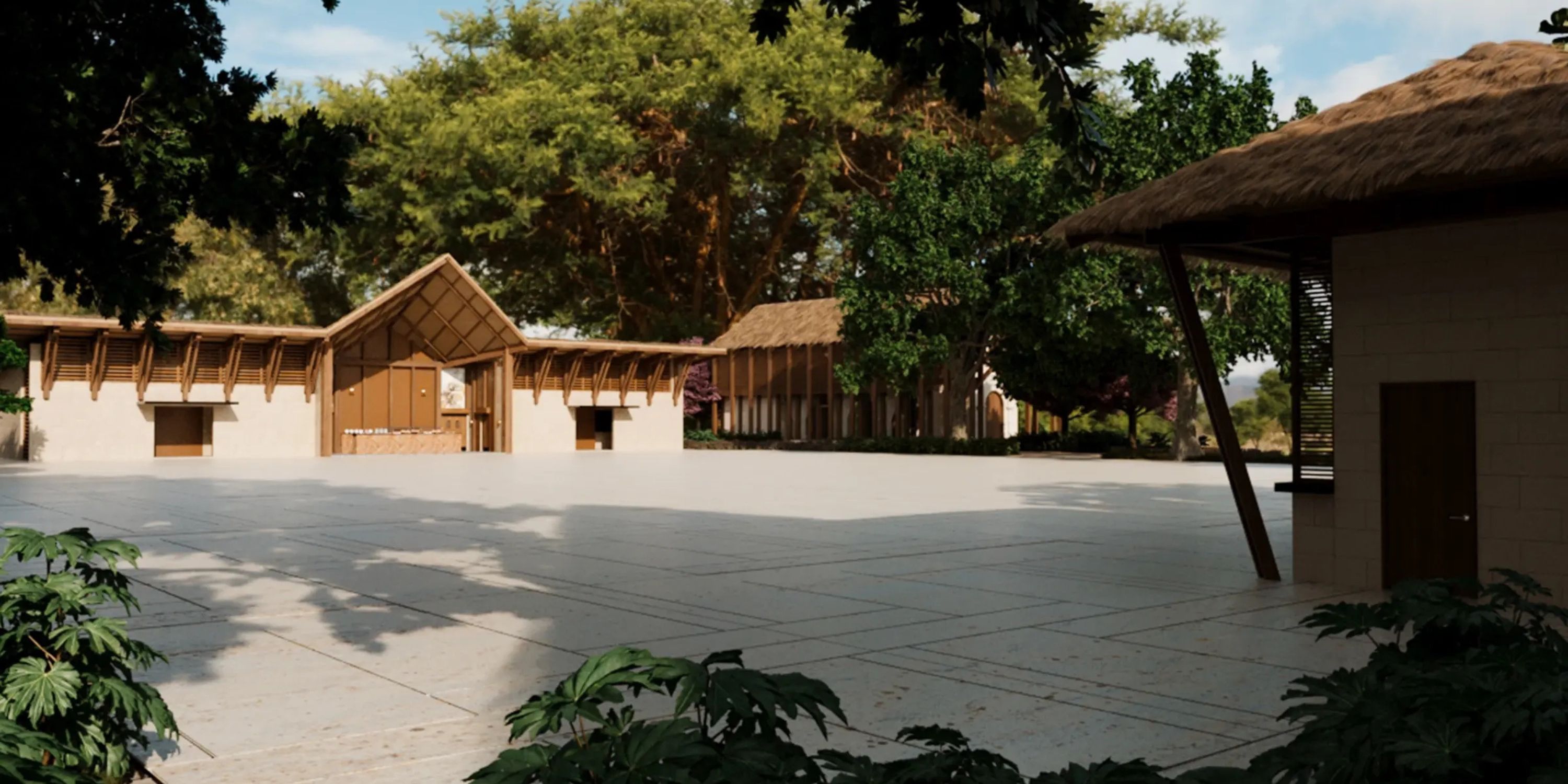 Open courtyard with trees, ideal for a destination wedding, surrounded by thatched-roof bamboo buildings.