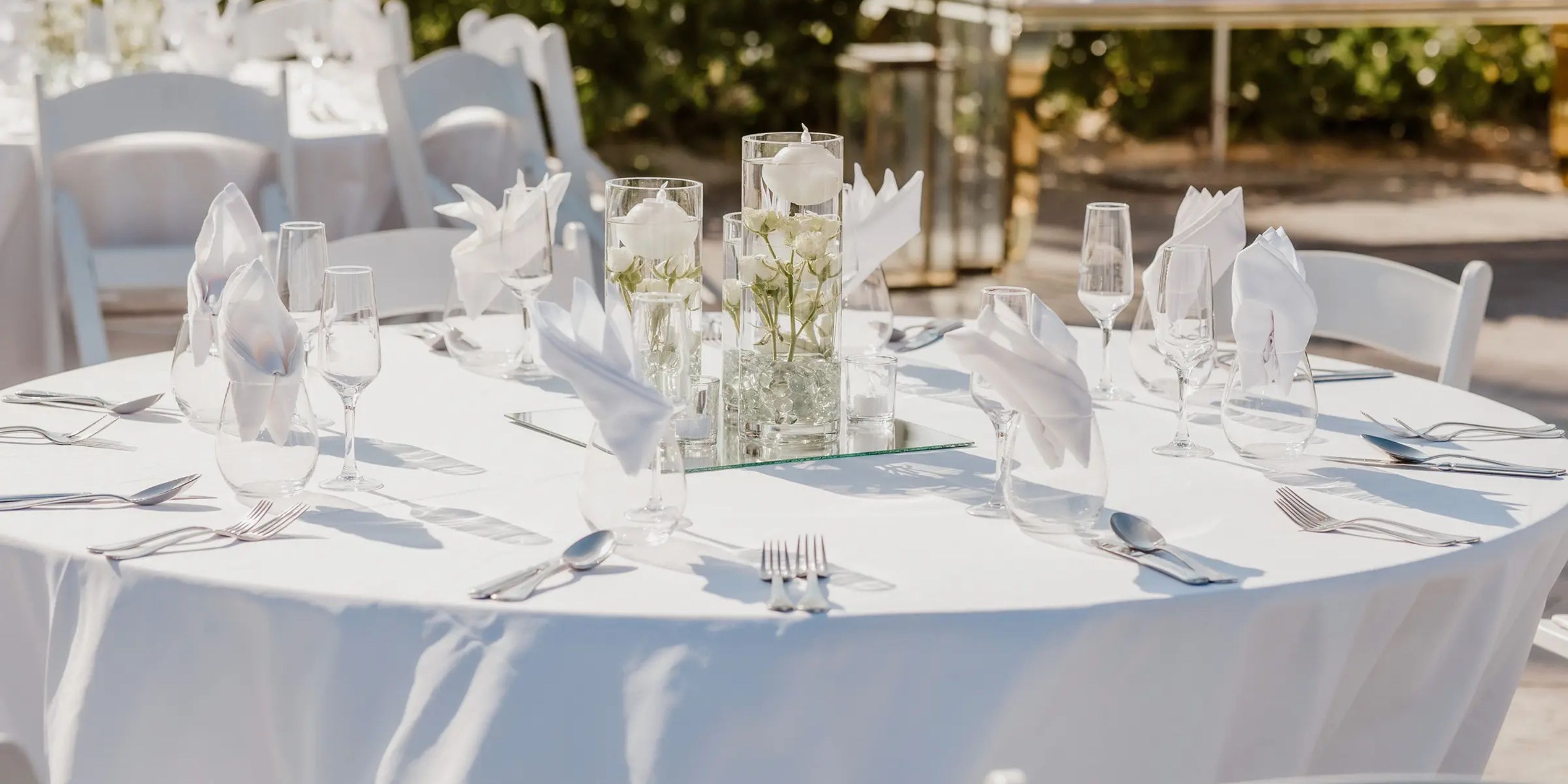 Wedding table setup at Moon Palace The Grand Punta Cana with white linens and floral centerpiece.