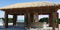 Open-air beach bar at Moon Palace The Grand, perfect for a destination wedding, with swings and sea views.