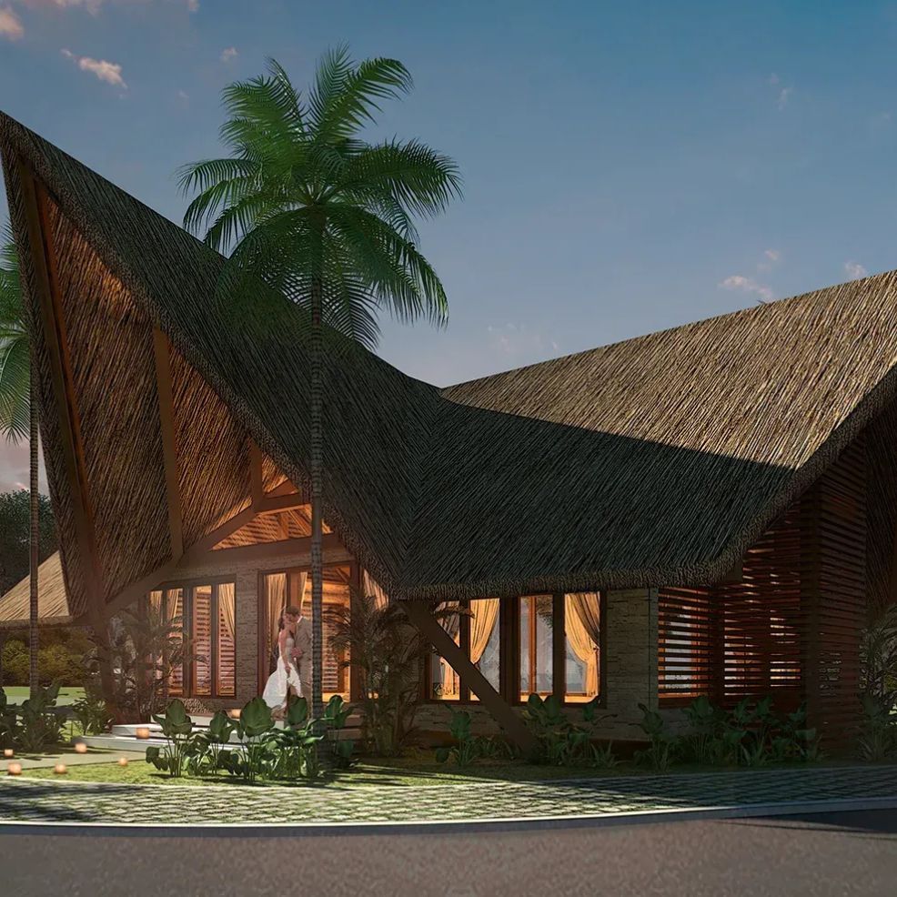 A modern house with a steep thatched roof and large windows, perfect for a destination wedding, surrounded by palm trees.