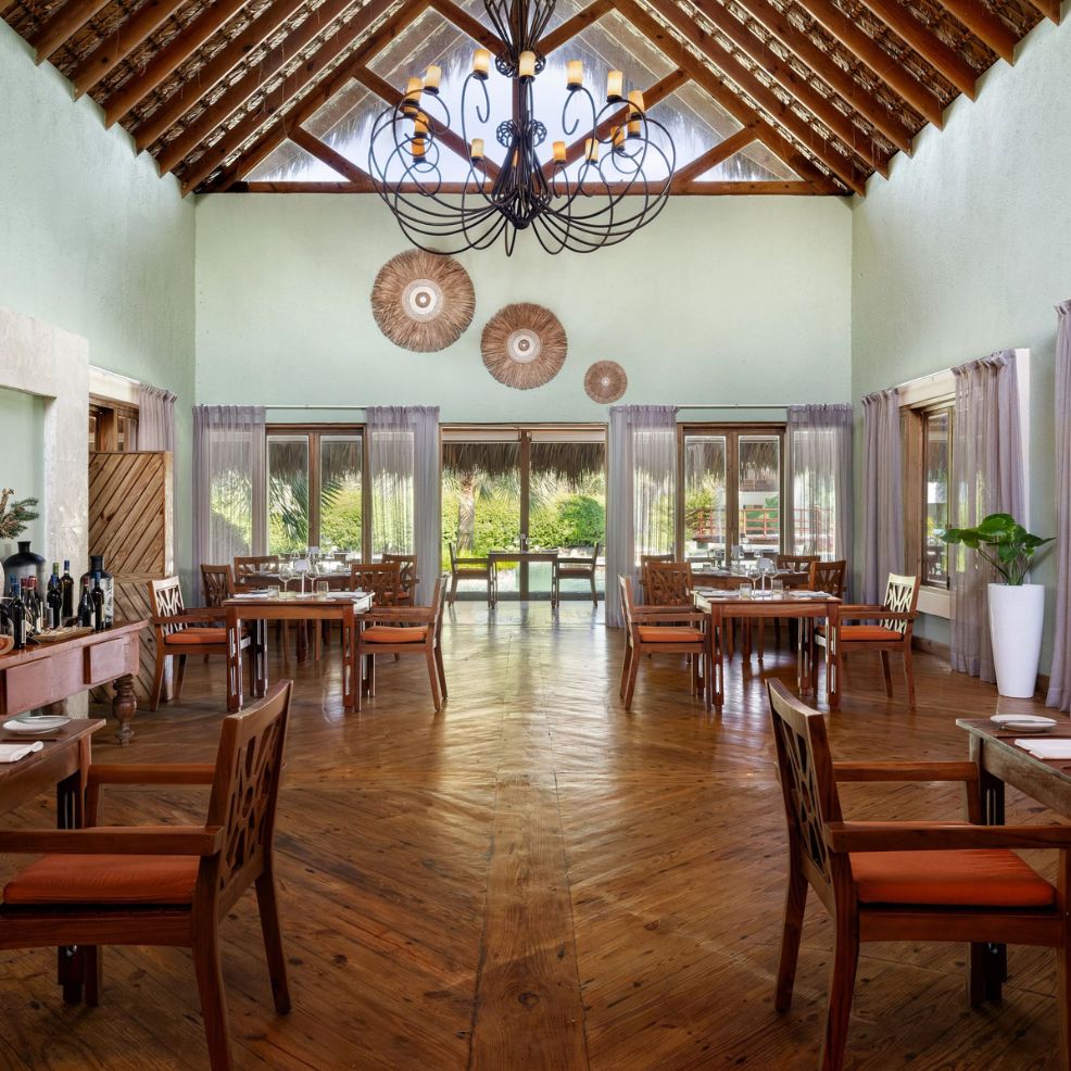 Elegant restaurant with wooden floors and high ceiling, perfect for destination wedding celebrations.