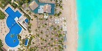 Aerial view of Catalonia Bayahibe resort, a stunning destination wedding spot with pools and turquoise water.
