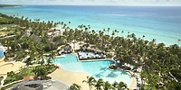 Aerial view of Catalonia Bayahibe, a beachfront resort with pools and palm trees&mdash;ideal for weddings.