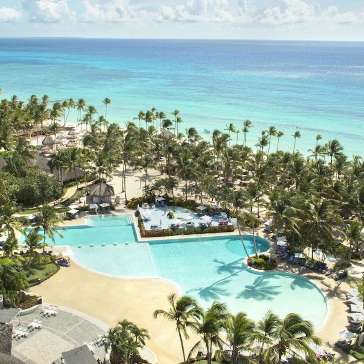 Catalonia Bayahibe&rsquo;s large pool with palm trees and ocean views makes a perfect destination wedding spot.
