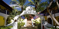 White arched entrance at Catalonia Bayahibe, perfect for a destination wedding, leads to outdoor stairs.