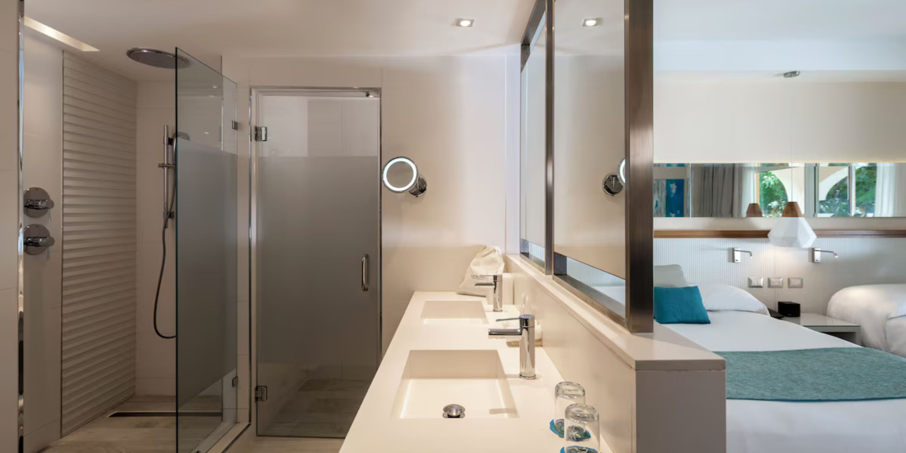Modern bathroom at Catalonia Bayahibe, ideal for destination wedding stays, with double sinks and glass shower.
