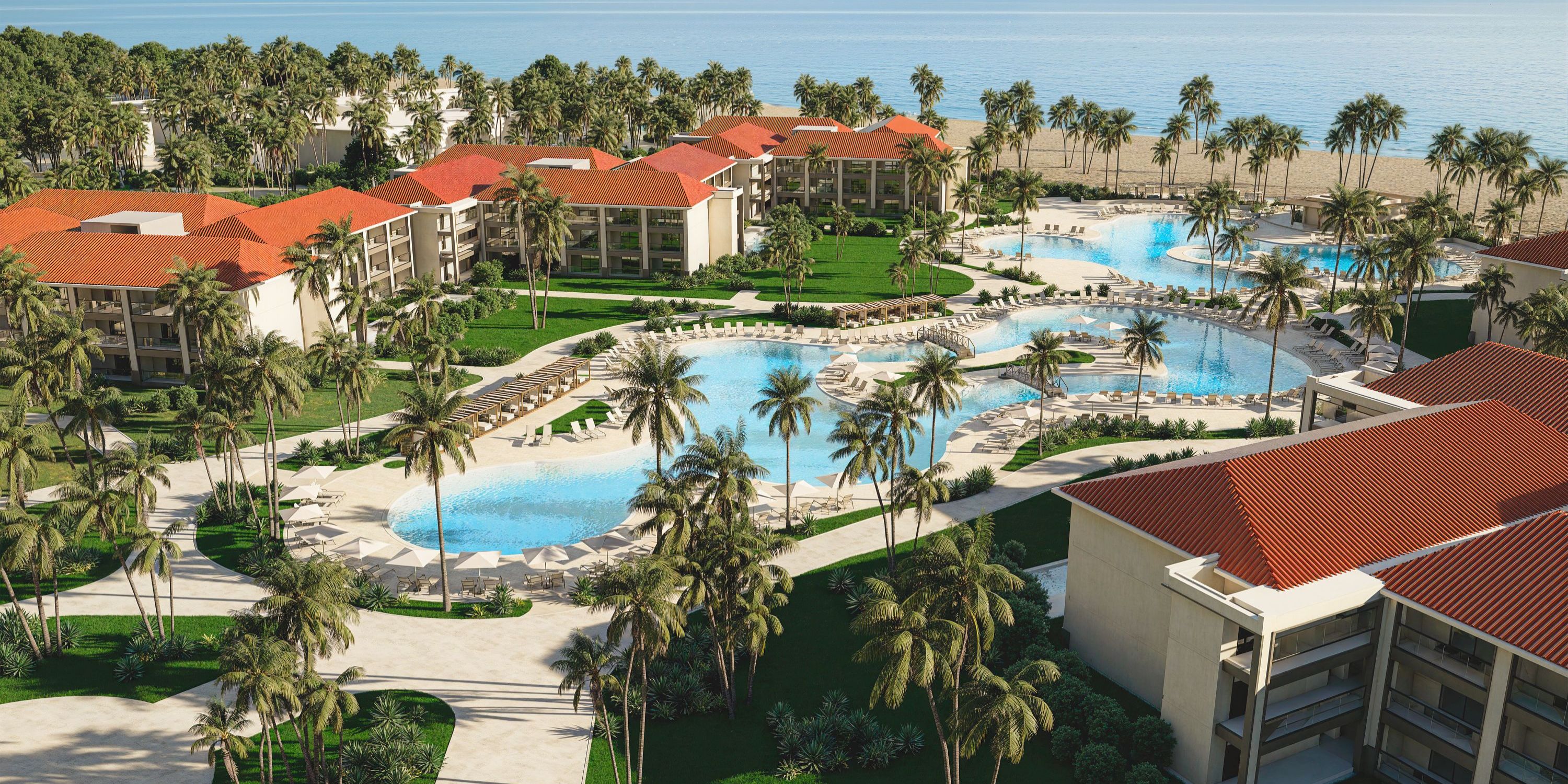 Aerial view of Hyatt Vivid Grand Island, a popular destination wedding spot with pools and red roofs.