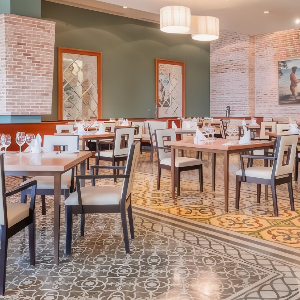 Modern restaurant dining area with patterned tile floors, ideal for a destination wedding reception.