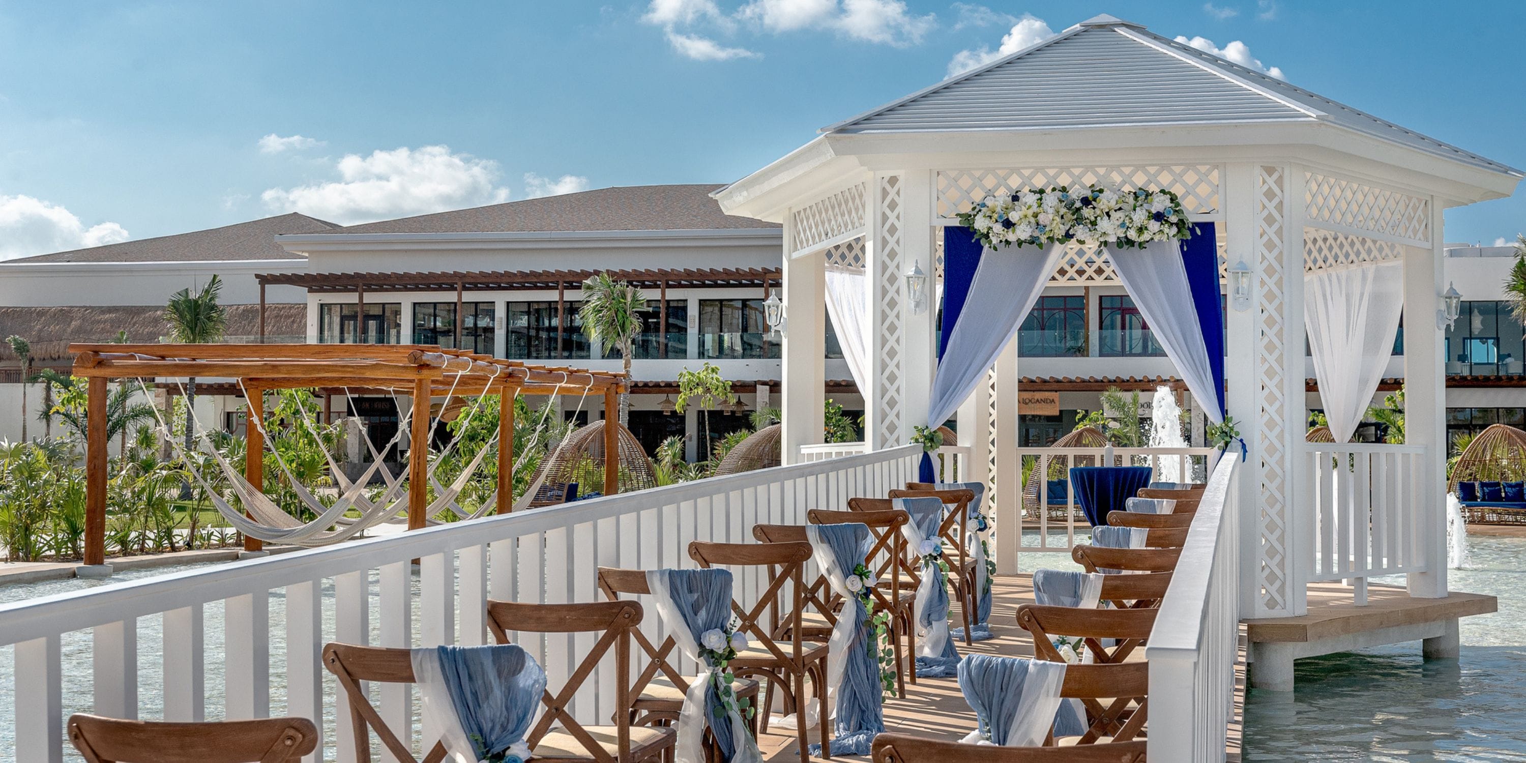 Ocean Allure Costa Mujeres gazebo prepared for a destination wedding, with chairs and blue accents over water.