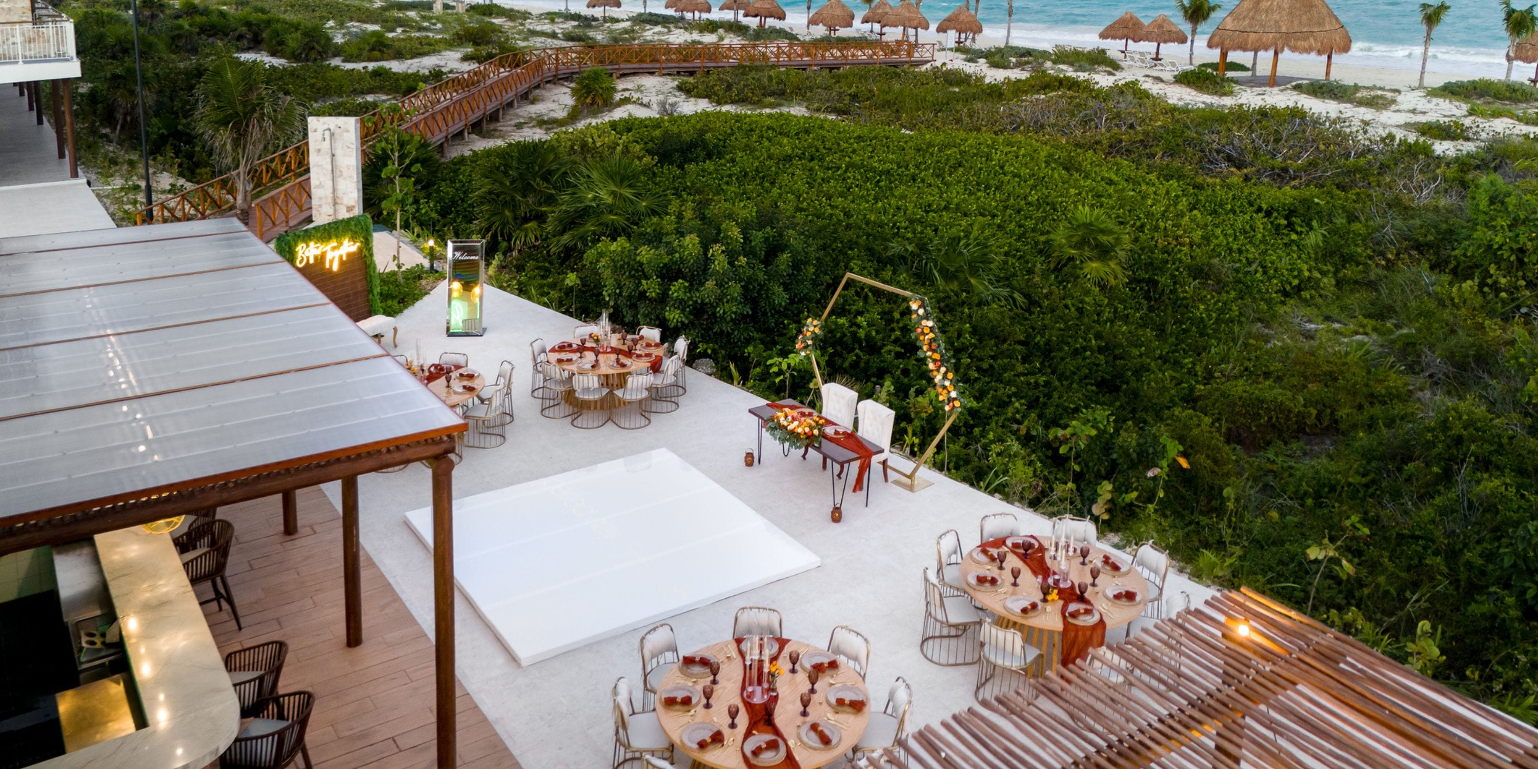 Ocean Allure Costa Mujeres: destination wedding venue with round tables, chairs, and oceanfront views.