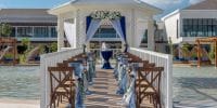 Wedding dock setup at Ocean Allure Costa Mujeres with chairs, blue decor, and gazebo for destination weddings.